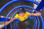 Fili tests out the play equipment. 133771 Picture: GARY SISSONS