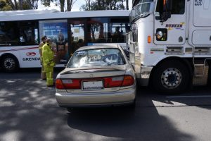 Woman's car struck by semi-trailer outside Parkmore shops