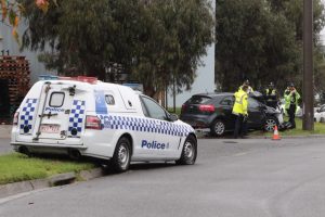 Police car slides into sign
