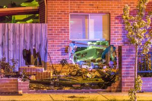 Driver flees after car crashes into kitchen