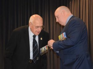 Mates celebrate belated honours