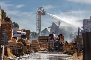 Timber pile sparks large fire