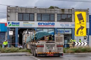 Truckie trapped in building crash