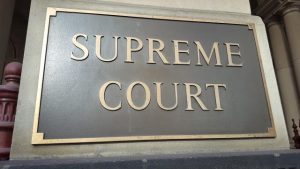 Son stayed with mother’s body after ‘savage’ beating